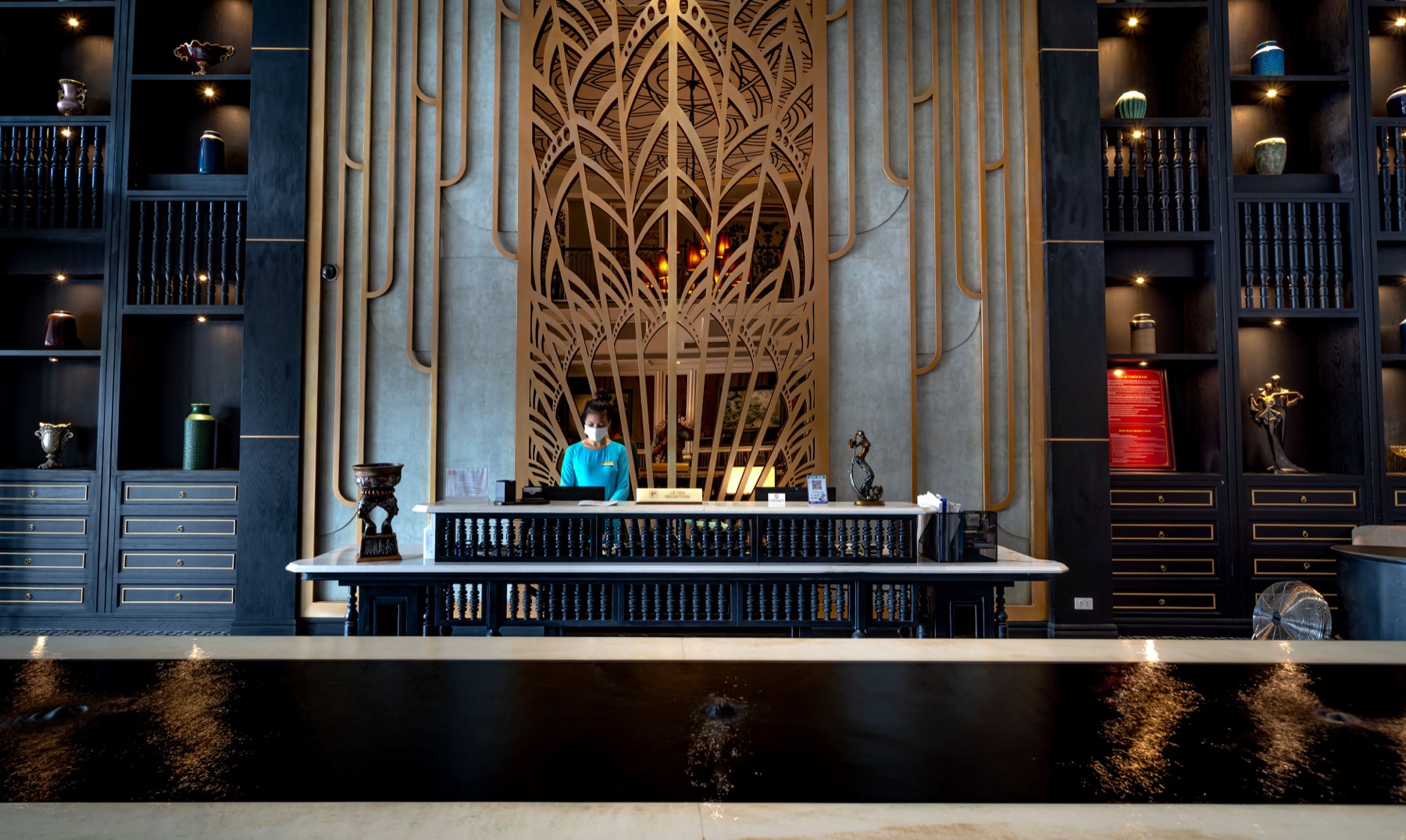 A receptionist at a hotel front desk.
