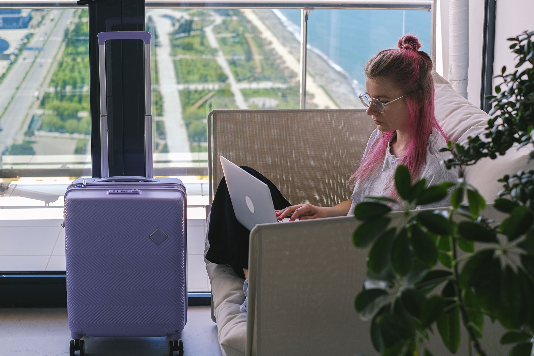 A guest working on a laptop in a hotel room.